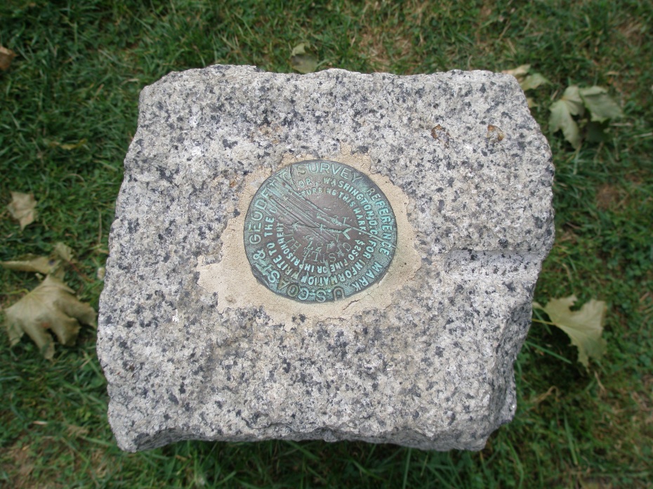 This is the only "garden ornament" at the Ocean End of the Allee: a tiny Geodetic Survey Marker...which is rather an anti-climax after Arthur Shurcliff's masterfully-orchestrated, half-mile-long swath of green. A series of low stone benches placed here on the promontory would quietly punctuate the Allee's termination, and would also provide a welcome resting spot.
