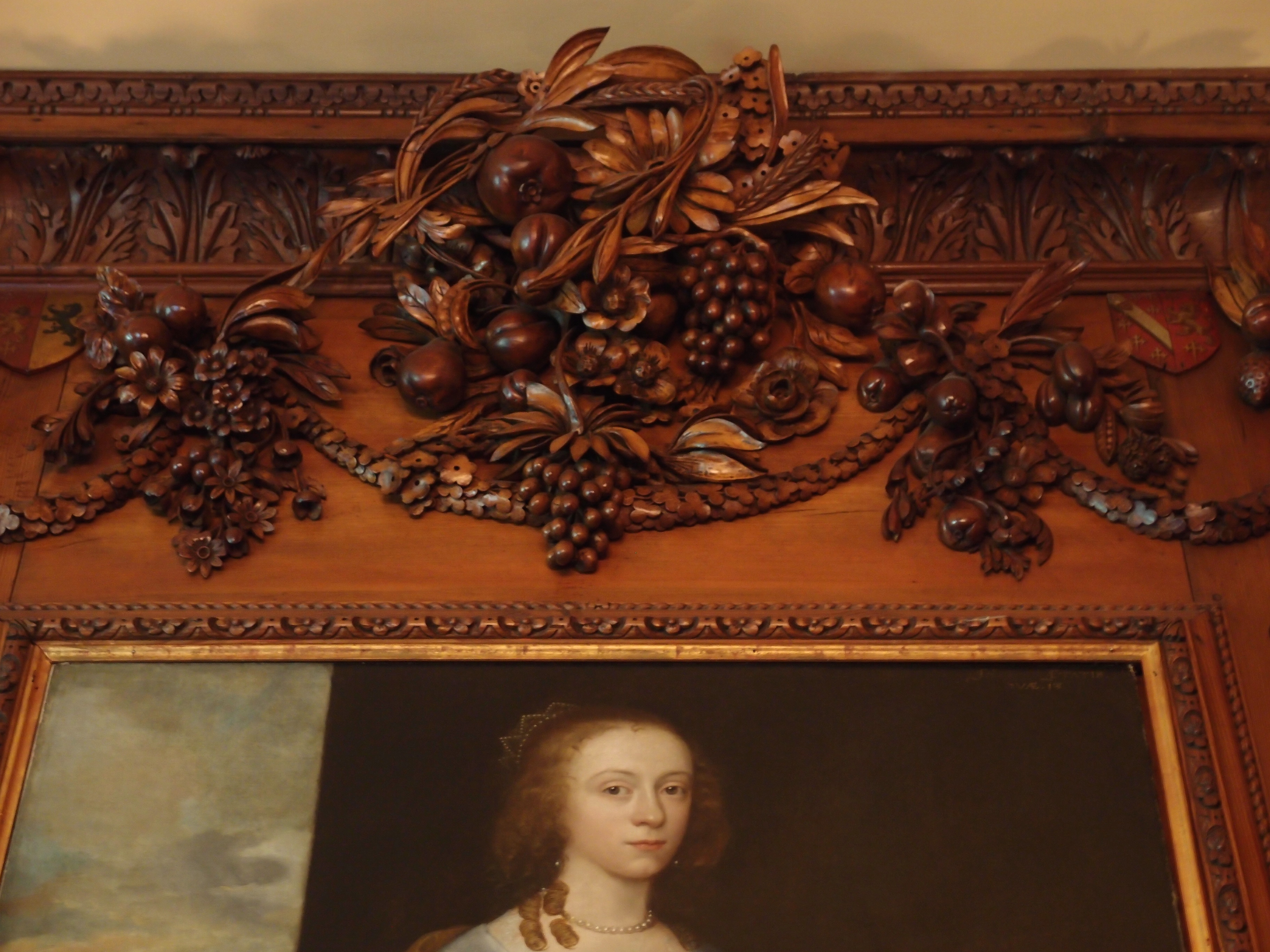 Grinling Gibbons' carvings crown---and rather outshine---a portrait of Lady Emma Anderton (which is actually OK, since Emma was simply a purchased portrait, and not a relative of the Crane family). This just goes to show, however, that even a beautiful lady cannot complete with Gibbons' artistry.